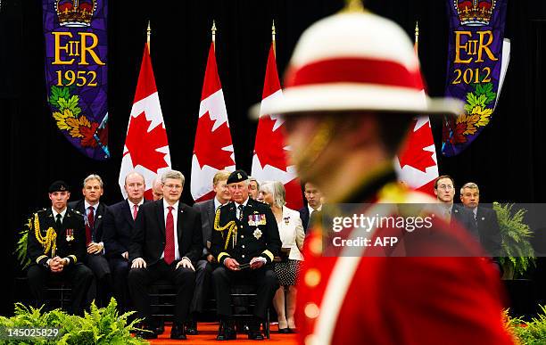 Britain's Prince Charles and Canada's Prime Minister Stephen Harper speak at the Fort York Armoury for the 1812 Commemorative Military Muster in...