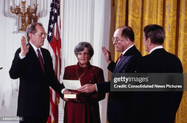 American lawyer and jurist Anthony Kennedy taking the constitutional oath as he becomes the 104th US Supreme Court Justice, as his wife, Mary...