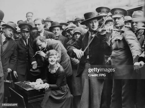 Dutch violinist David de Groot with musicians performing outside the London Coliseum in St Martin's Lane, London, England, circa 1925. Also in the...