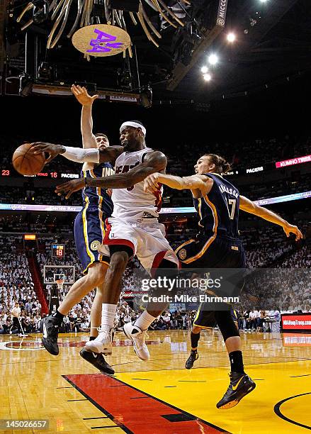 LeBron James of the Miami Heat passes away from Tyler Hansbrough and Louis Amundson of the Indiana Pacers during Game Five of the Eastern Conference...