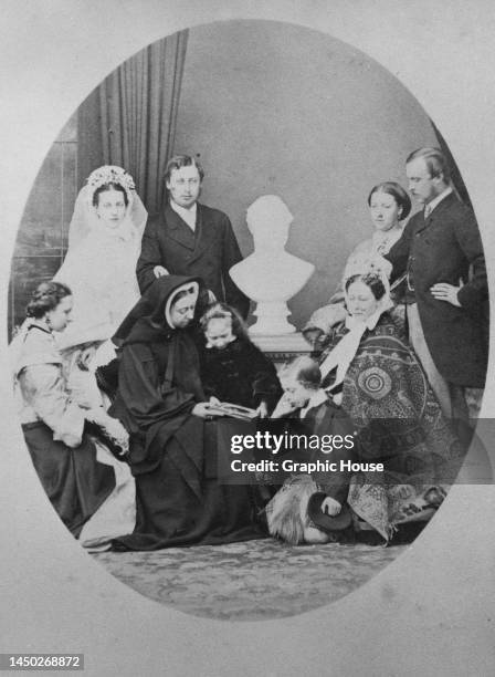 Queen Victoria dressed in mourning black beside a bust of Albert, Prince Consort, and her family - Prince Alfred , Edward, Prince of Wales , and his...