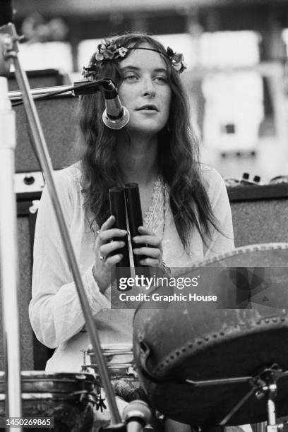 British singer and songwriter Licorice McKechnie playing a pair of claves as her band, The Incredible String Band, perform live at the Woodstock...