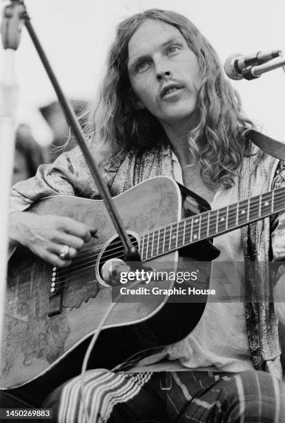 British singer, songwriter and musician Robin Williamson as his band, The Incredible String Band, perform live at the Woodstock Music and Art Fair in...