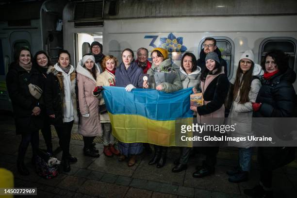 Oleksandra Matviichuk , head of the Center for Civil Liberties awarded this year’s with the Nobel Peace Prize, holds Ukrainian flag with colleagues...