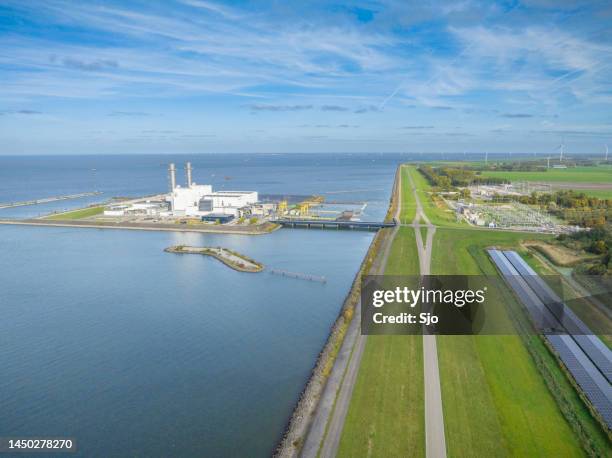 maxima-centrale powerplant on the shore of the ijsselmeer - centrale bank stock pictures, royalty-free photos & images