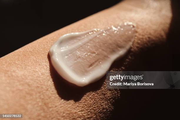 a smear of white moisturizer on the hand. - celulite stock pictures, royalty-free photos & images