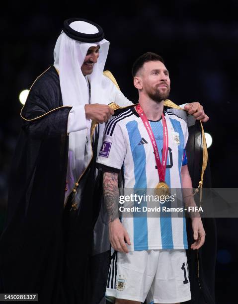 Lionel Messi of Argentina is presented with a traditional robe, bisht, by Sheikh Tamim bin Hamad Al Thani, Emir of Qatar, during the awards ceremony...