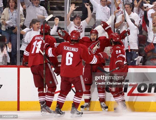Marc-Antoine Pouliot of the Phoenix Coyotes celebrates his second period goal with teammates Martin Hanzal, David Schlemko and Kyle Chipchura against...