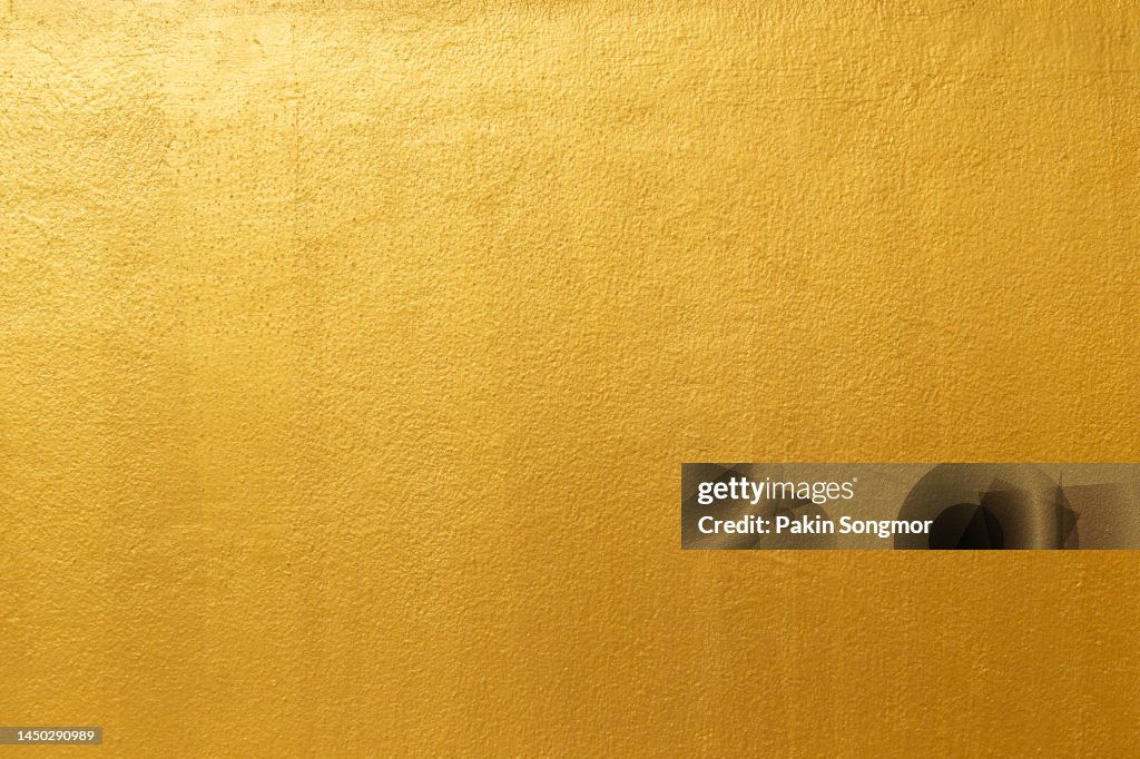 Golden color with an old grunge wall concrete texture as a background.