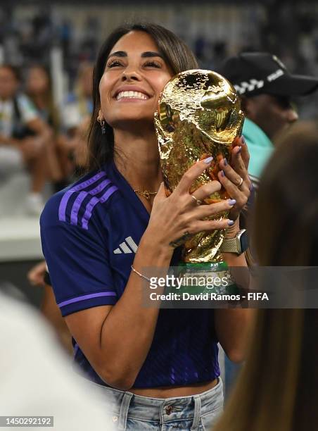 Antonela Roccuzzo, wife of Lionel Messi of Argentina celebrates with the FIFA World Cup Qatar 2022 Winner's Trophy after the team's victory during...