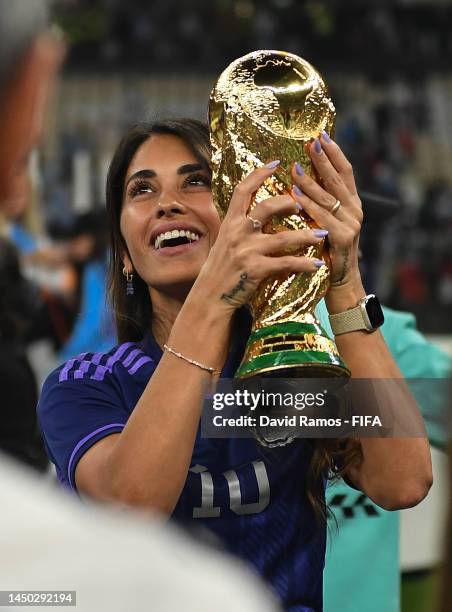 Antonela Roccuzzo, wife of Lionel Messi of Argentina celebrates with the FIFA World Cup Qatar 2022 Winner's Trophy after the team's victory during...