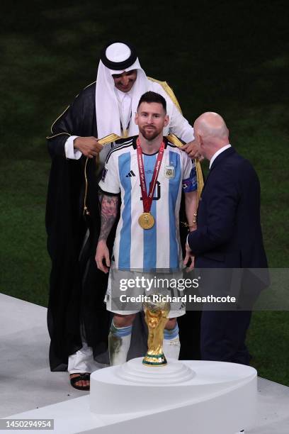 Lionel Messi of Argentina is presented with a traditional robe by Sheikh Tamim bin Hamad Al Thani, Emir of Qatar, during the awards ceremony after...