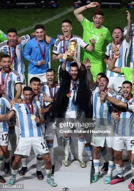 Lionel Messi of Argentina lifts the FIFA World Cup Trophy after the team's victory during the FIFA World Cup Qatar 2022 Final match between Argentina...