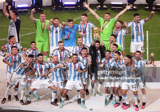 Lionel Messi of Argentina lifts the FIFA World Cup Trophy after the team's victory during the FIFA World Cup Qatar 2022 Final match between Argentina...