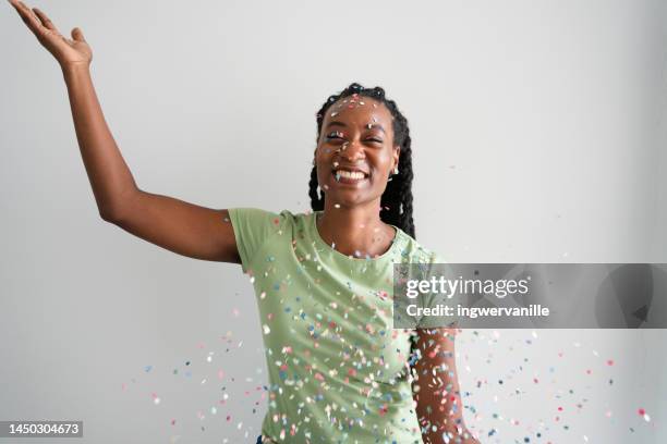 happy young woman with confetti falling on her - glitter face stock pictures, royalty-free photos & images