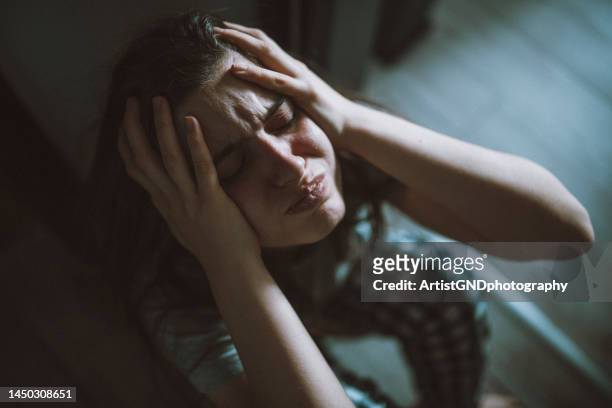 frustrated woman with her head in her hands. - psychopath stock pictures, royalty-free photos & images