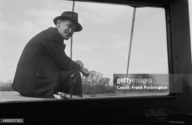 The view from inside the bow of a narrow boat towards a passenger on the Grand Union Canal, England. Picture Post - 7798 - The Scandal of our...