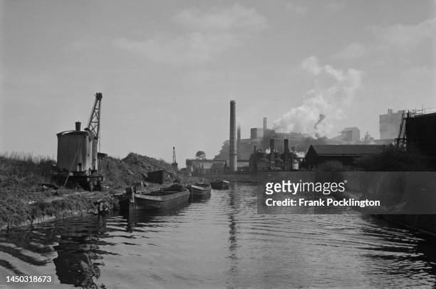 Industrial buildings and smokestacks on the Grand Union Canal, England. Original Publication: Picture Post - 7798 - The Scandal of our Waterways -...