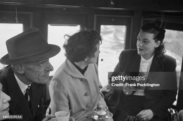 Passengers enjoy a cup of tea inside a narrow boat on the Grand Union Canal, England. Original Publication: Picture Post - 7798 - The Scandal of our...
