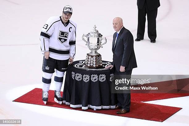 Dustin Brown of the Los Angeles Kings poses NHL Deputy Commissioner Bill Day as he presents the Clarence Campbell Bowl after the Kings 4-3 victory...