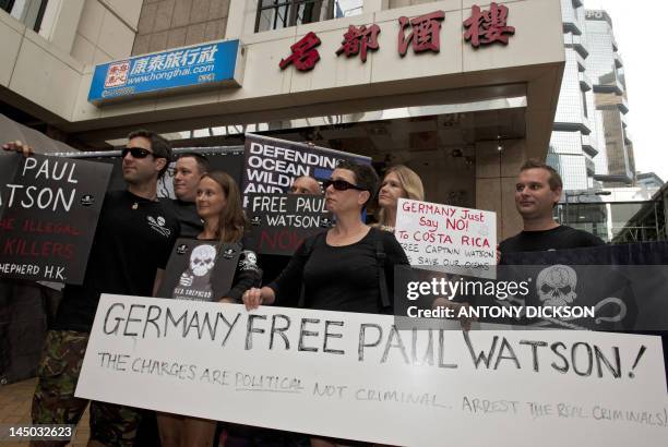 Protesters from conservation group Sea Shepherd hold placards asking the German government to free environmental group Sea Shepherd leader Paul...