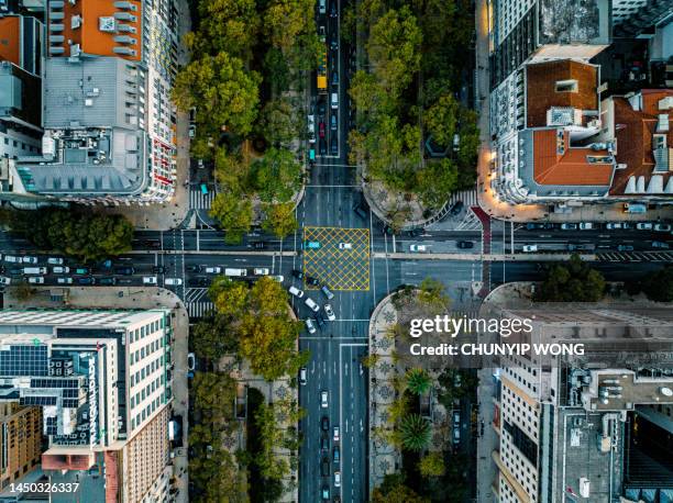 top down aerial view of cars driving through intersection at lisbon - crossing road stock pictures, royalty-free photos & images