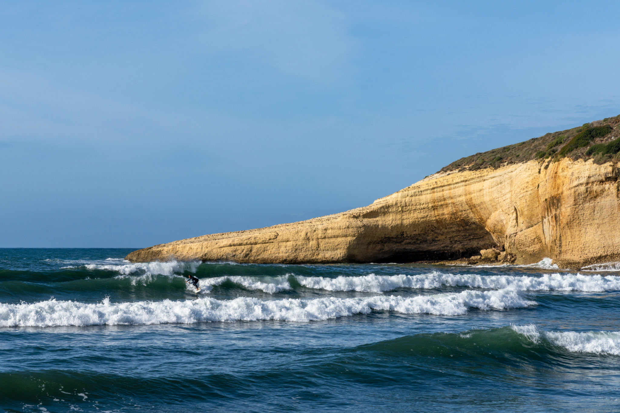 surfer enjoying good waves on the west coast of Sardinia during a good winter swell surfer enjoying good waves on the west coast of Sardinia during a good winter swell