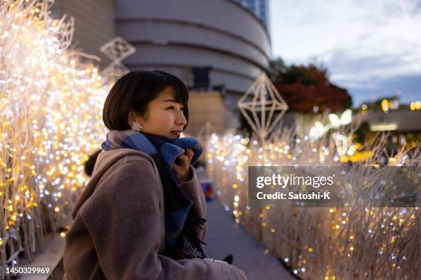 side view of young woman looking at christmas lights - osaka city 個照片及圖片檔