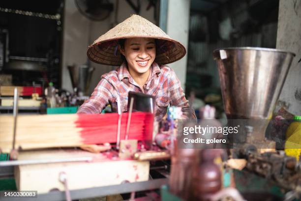 smiling vietnamese woman manufacturing incense sticks - village trestle stock pictures, royalty-free photos & images