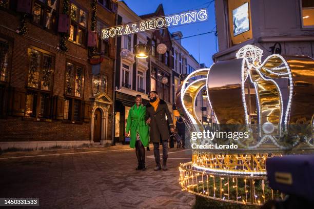 a beautiful black couple at christmas winter shopping in the hague - netherlands christmas stock pictures, royalty-free photos & images