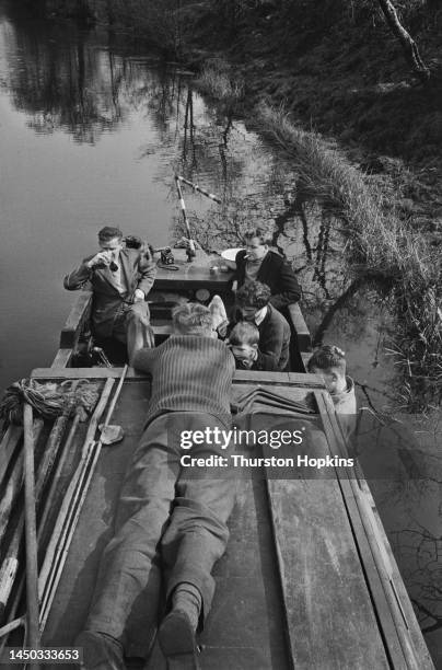 Passengers relaxing on a narrow boat travelling on the Grand Union Canal, England. Original Publication: Picture Post - 7798 - The Scandal of our...