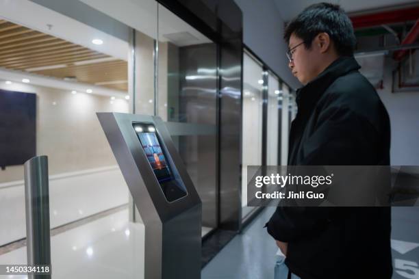 man uses facial recognition technology to unlock door - access control stock pictures, royalty-free photos & images