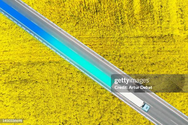 creative aerial overhead view of the semitruck ecologic print left through natural environment. - agricultural policy stock pictures, royalty-free photos & images