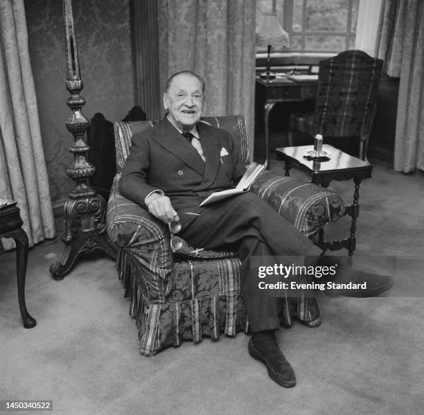 British writer W Somerset Maugham sitting in an armchair with a book on April 29th, 1961.