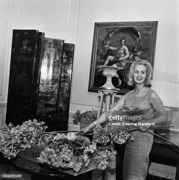 Carolyn Doran-Webb, one of J Paul Getty's female companions, arranging flowers ahead of a party at the billionaire industrialist's Sutton Place...