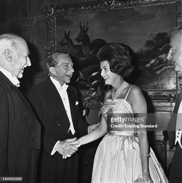 Billionaire industrialist J Paul Getty shaking hands with Lady Beatty as he welcomes guests to his party at Sutton Place in Surrey on July 2nd, 1960.