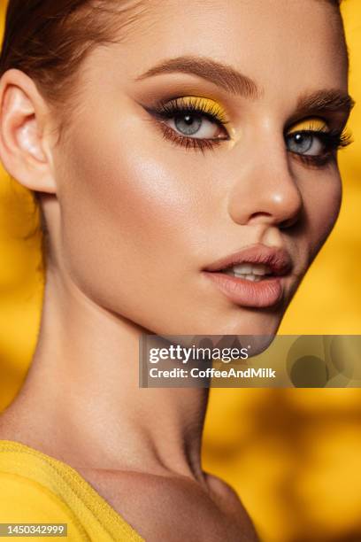 beautiful woman with bright make-up - yellow eyeshadow stock pictures, royalty-free photos & images