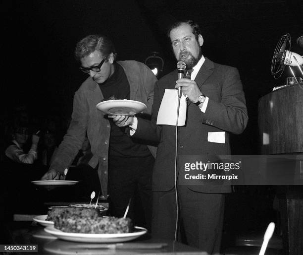 Clement Freud and actor Michael Caine as judges at the first annul England bread pudding finals. December 1967.