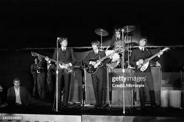 The Beatles performing on stage at the Forest Hills Tennis Stadium in New York during the tour of USA. 28th August 1964. Left to right: Paul...