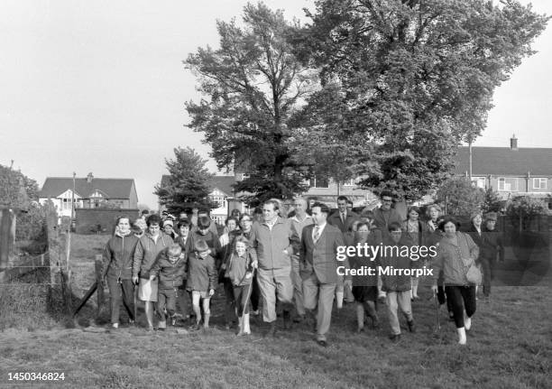 More than 60 Allesley residents discovered the countryside by following local footpaths shown to them by Mrs Molly Gibson, seen here climbing over...