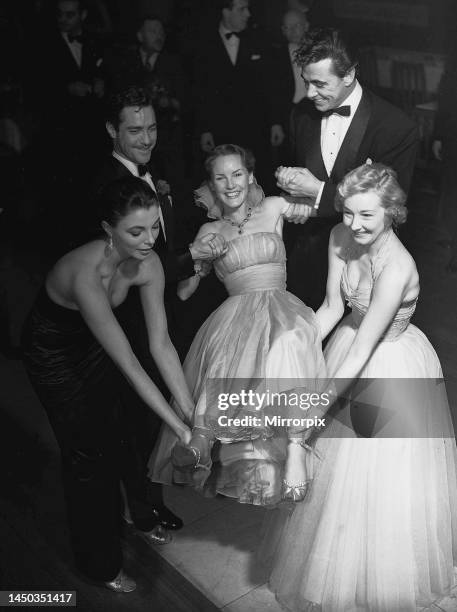 Petula Clark gets a lift on her 20th birthday from Joan Collins, Richard Todd, Maxwell Reed and Joan Dowling. 1952.