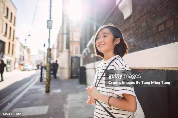 beautiful tourist girl exploring in the city joyfully - pre adolescent child stock pictures, royalty-free photos & images