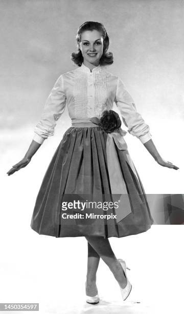 Reveille fashion 1959: Roma Reeves modelling a balloon skirt and blouse with flower detail belt. December 1959.