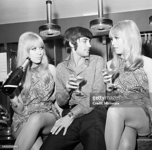 Manchester United footballer George Best celebrates the opening of his fashion boutique with a few glasses of champagne. 14th September 1967.