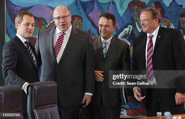 New German Environment Minister Peter Altmaier stands with Health Minister Daniel Bahr, Interior Minister Hans-Peter Friedrich and Development...