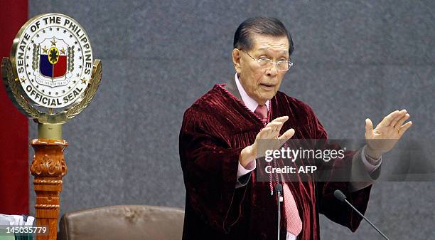 Senate President Juan Ponce Enrile gestures during the impeachment trial of Supreme Court Chief Justice Renato Corona at the Senate headquarters in...