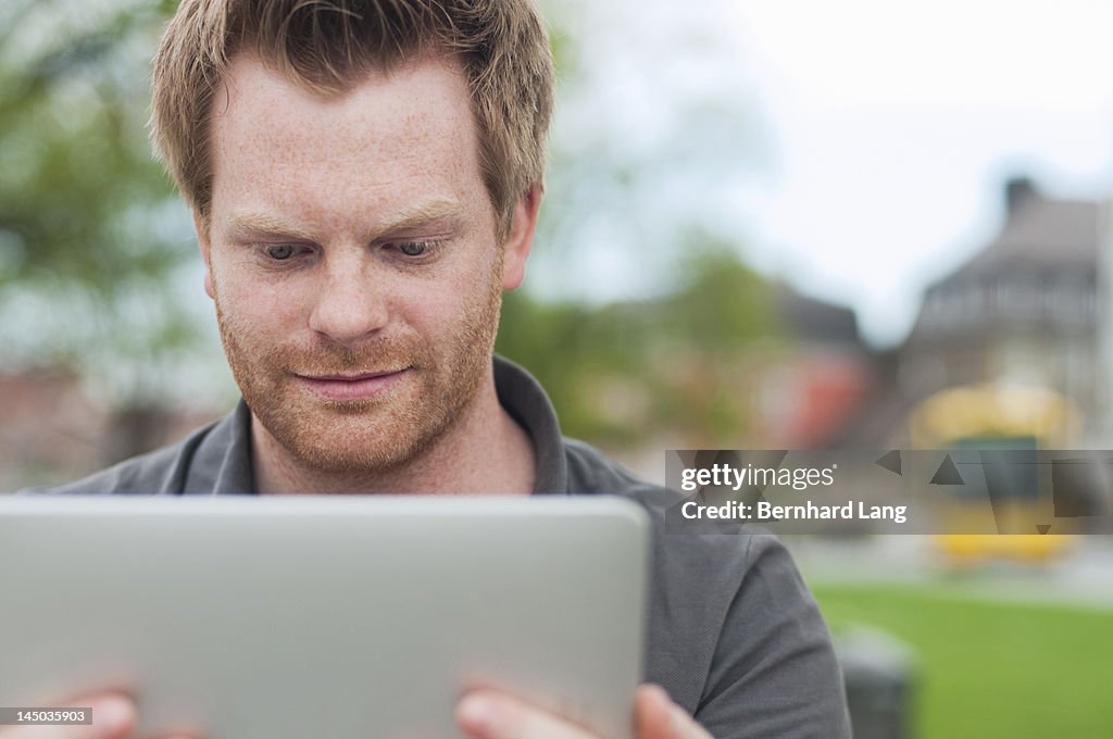 Young man looking on tablet computer