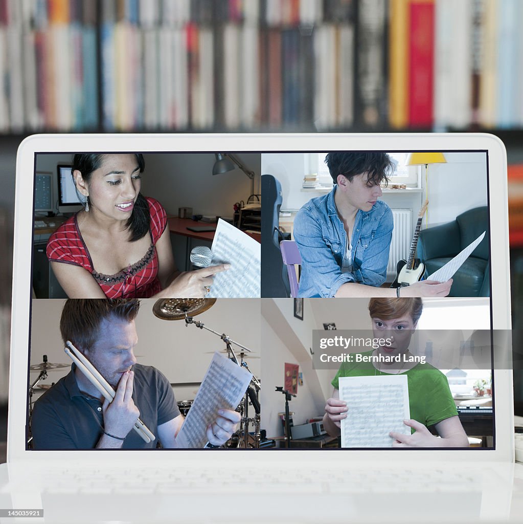 4 musicians discussing online, displayed on laptop