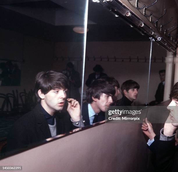 The Beatles at the De Montfort Hall in Leicester 10 October 1964 Reflected in the mirror of the dressing room left to right: Paul McCartney, George...