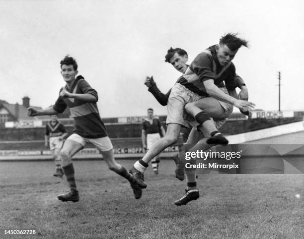 Gaelic games. In this game you just don't need a ball or so it would appear from this picture. The gent flying through the air is a member of the...